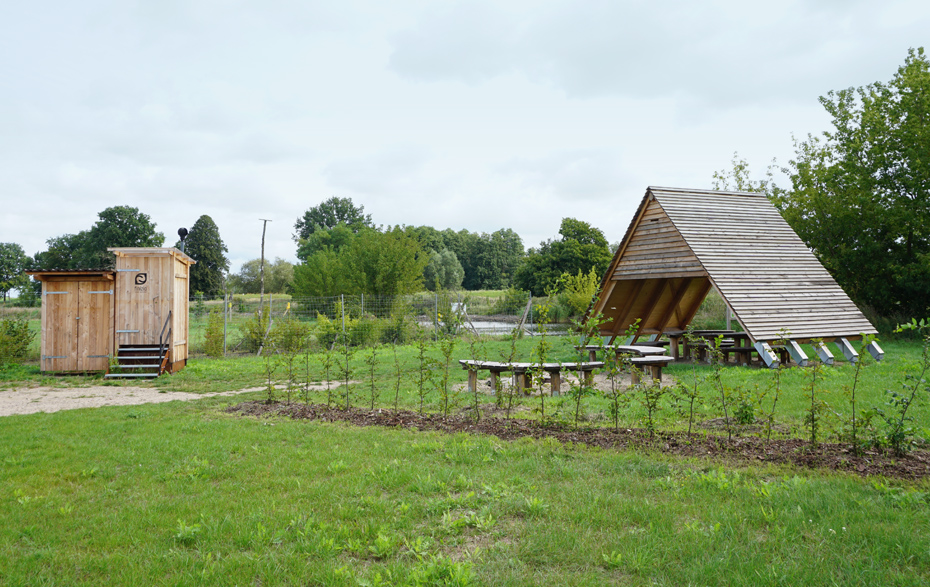 Foto: Sitzmöglichkeiten, Überdachung und Toilette am Ufer des Kanals