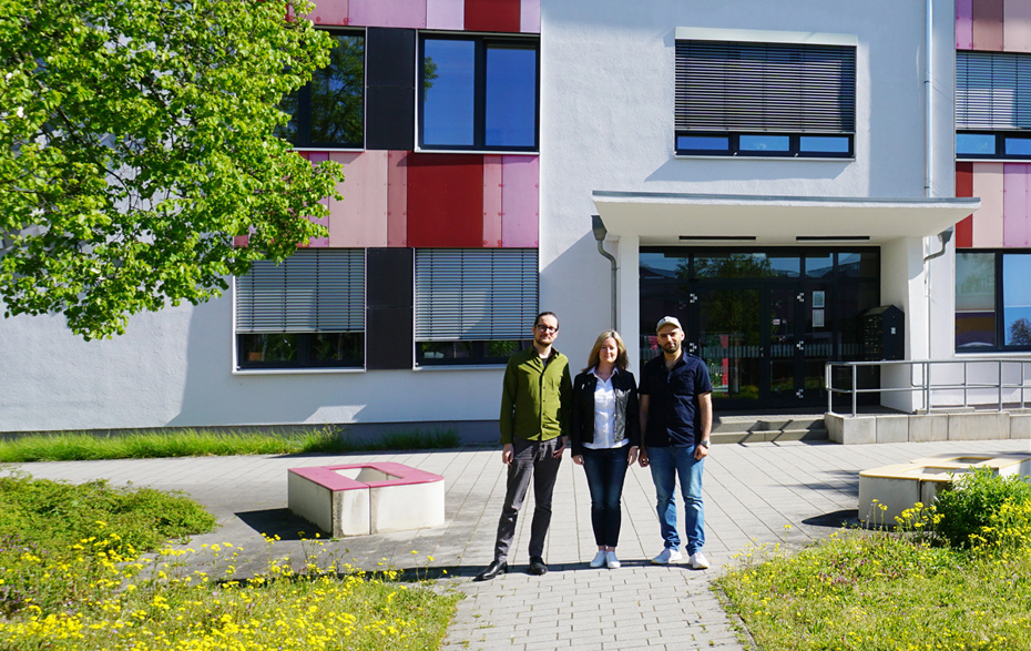 Foto: 3 Personen vor dem Eingang vom Haus der Bildung und Technologie